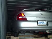 Nissan Altima loaded on ramp in middle of container